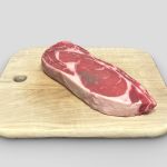 Boneless Ribeye steak on chopping board
